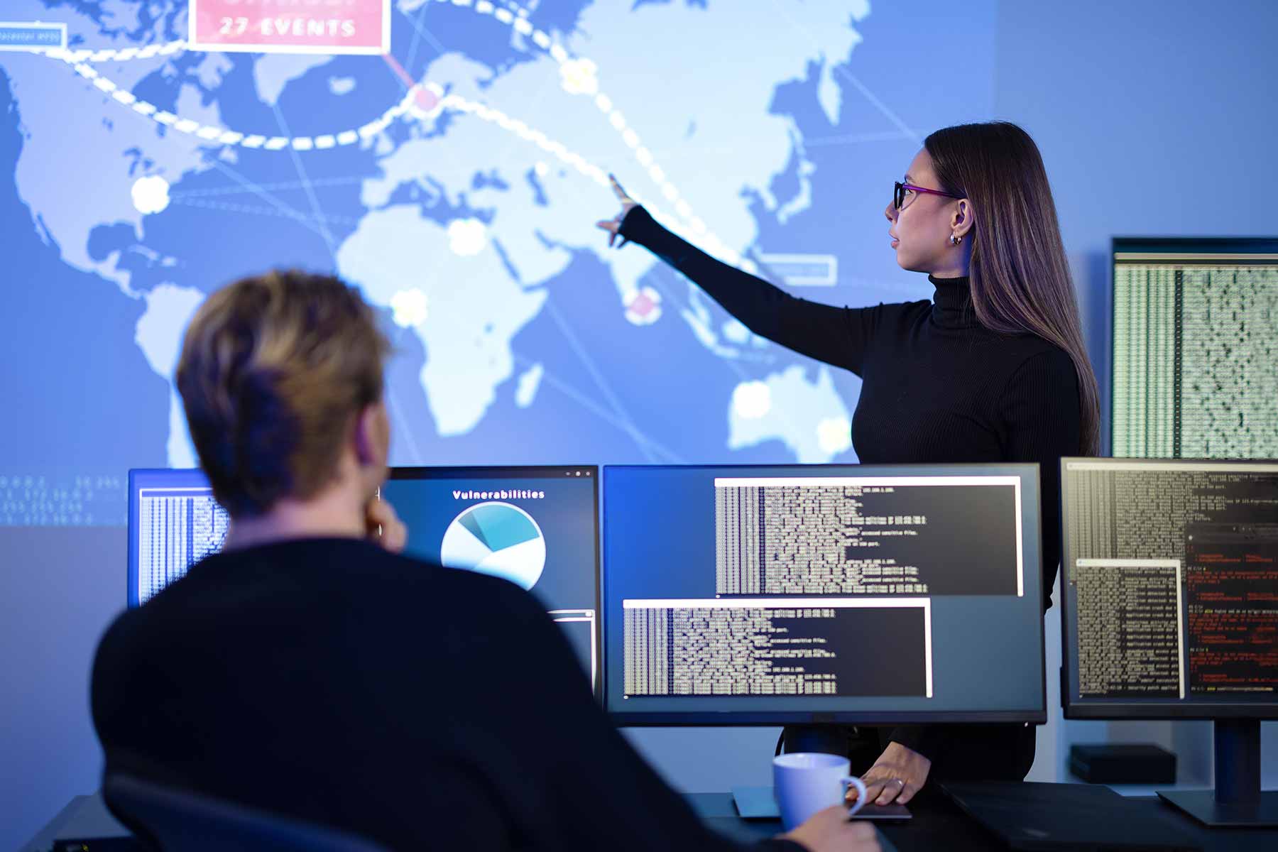 Team of cybersecurity professionals analyzing global threats to their company's network