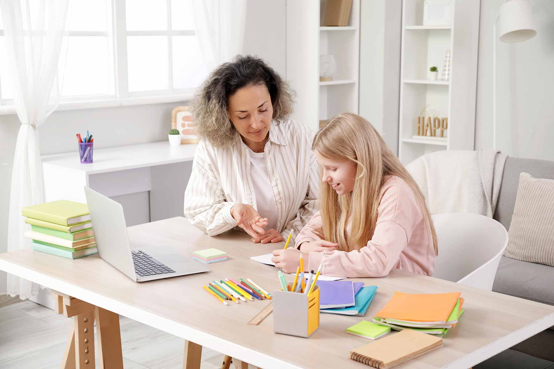 A tutor guiding a student during a study session at home